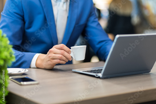 Businessman with espresso during work © Minerva Studio