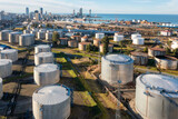 Aerial view of oil and gas terminal with steel storage tanks of oil and LPG petrochemical. Oil tank farm for gas, diesel and petroleum in a sea port near industrial plant and chemical refinery