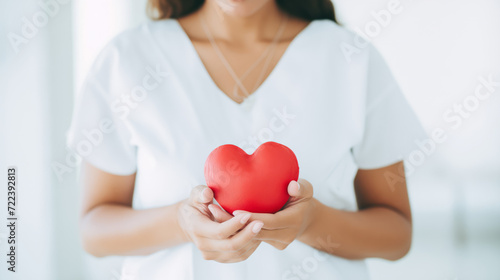 Compassionate nurse presents heart, emphasizing cardiac care, safety life