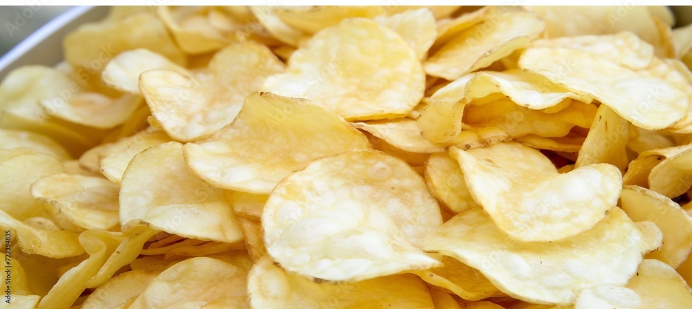 Automated production and packaging line of potato chips on conveyor belt for crispy snacks