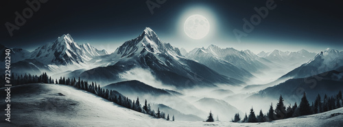 panesaggio notturno illuminato dalla luce di una grande luna piena con cime di monti innevati e vallate nebbiose photo