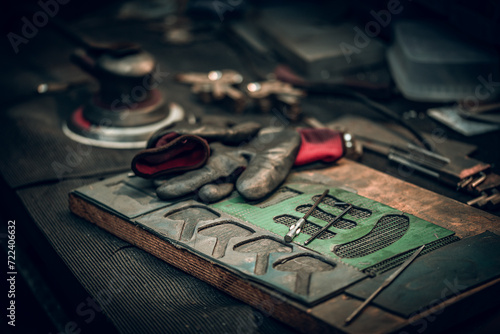 Templates for parts, tools and glows left on a work desk at the workshop