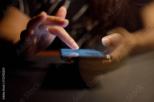 Close up of person looking at mobile phone  Online social addict