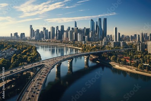 Drone view of a modern cityscape with a majestic bridge spanning across a river