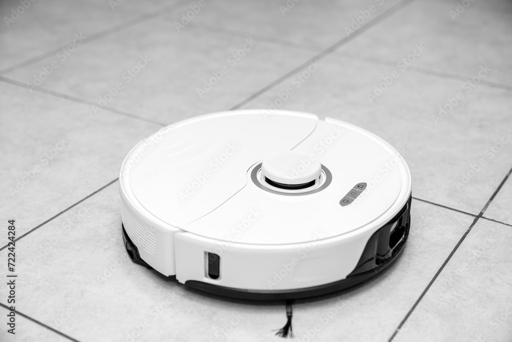 robot vacuum cleaner in modern smart home, robotic vacuum cleaner on tiles floor, Robot vacuum cleaner cleaning dust on tile floors. Modern smart cleaning technology housekeeping. robot vacuum cleaner in modern smart home, robotic vacuum cleaner on tiles floor, Robot vacuum cleaner cleaning dust on tile floors. Modern smart cleaning technology housekeeping.