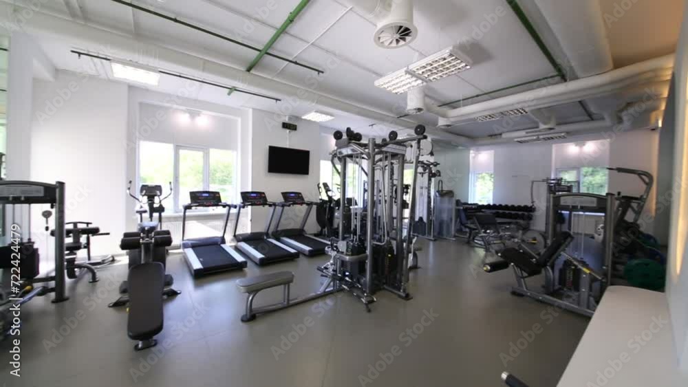 The interior of the gym with trainers at the modern fitness center The interior of the gym with trainers at the modern fitness center