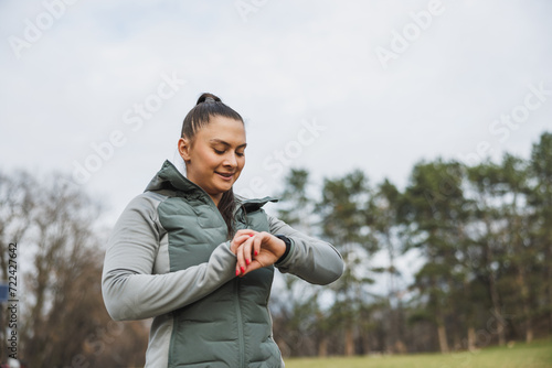 Woman Looking On Smart Watch After Training Outdoor