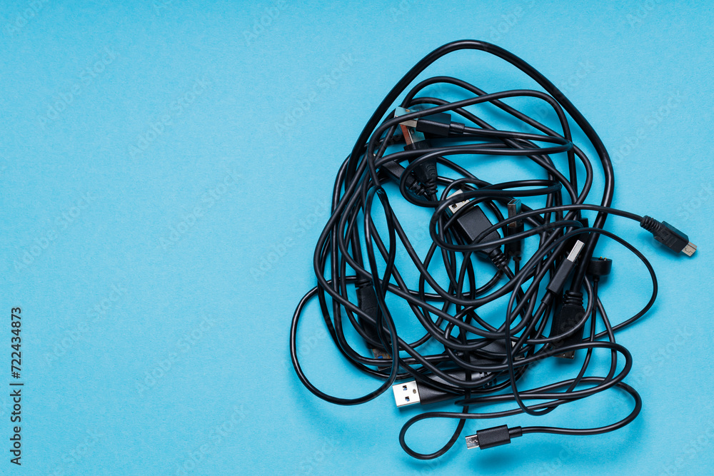 Disordered Black Cables on Blue Surface, Copy Space Disordered Black Cables on Blue Surface, Copy Space