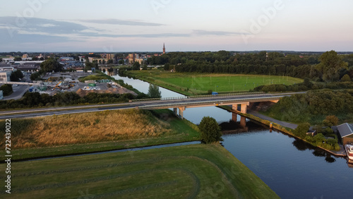 Aerial drone view of the canal and the Ruksveense Brug bridge in Steenwijk, Overijssel, The Netherlands. With the city centre, homes and the Steenwijker toren in the background.