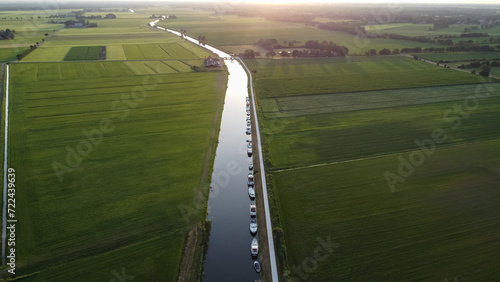 Aerial drone view of the Steenwijkerdiep canal next to farmland, meadow, nature landscape in Steenwijk, The Netherlands. Top view, captured from above with a drone. photo