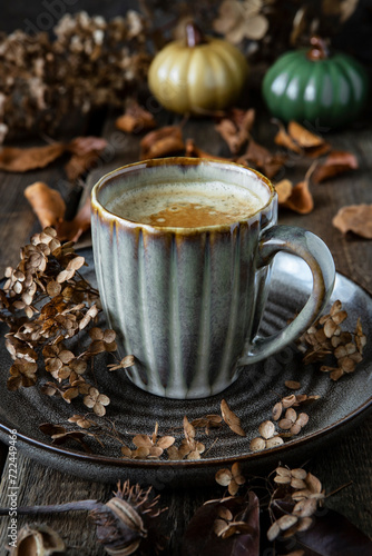 Still life with coffee cup on wooden background