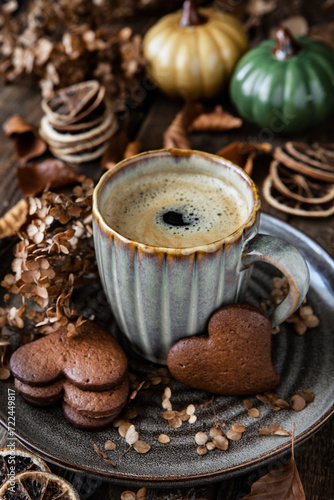 Composition with coffee in  ceramic mug  on dark wooden background