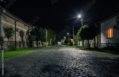 Fototapeta Naklejka Na Ścianę i Meble -  Night cobbled street in a small town in summer in summer. Night