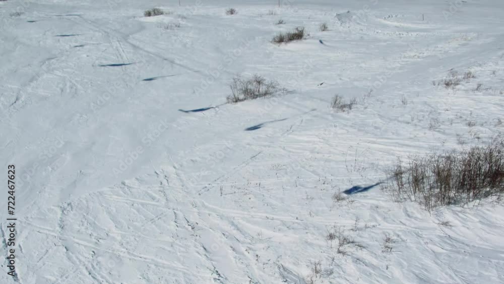 People ride on ski and snowboards by snowy mountain slope at winter People ride on ski and snowboards by snowy mountain slope at winter
