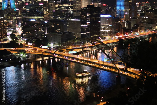 Downtown at night. View of the city lights and landscape. Panoramic view of the bridge and river in the downtown city of Pittsburgh, Pennsylvania —aerial, birds' eye view of downtown and river. © Jessica Brouillette