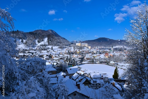 View of the town of Škofja Loka and the castle above in Gorenjska, Slovenia with forest covered Lubnik hill in the bacground © kato08