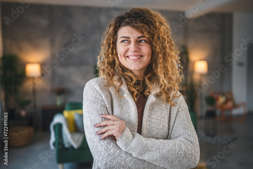 Portrait of adult caucasian woman with curly hair at home happy smile