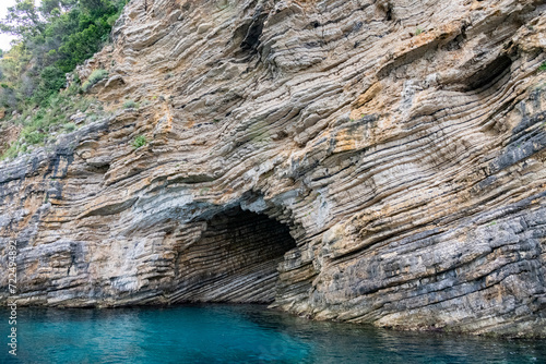 Scenic landscape of Island of Corfu  Greece  western shoreline with cliffs and caves at beach and water line of turquoise or deep blue water with breath taking limestone formations
