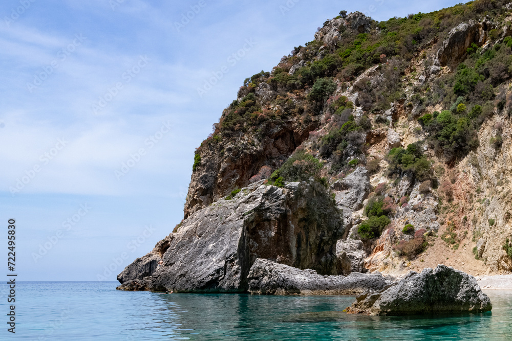 Scenic landscape of Island of Corfu, Greece, western shoreline with cliffs and caves at beach and water line of turquoise or deep blue water with breath taking limestone formations Scenic landscape of Island of Corfu, Greece, western shoreline with cliffs and caves at beach and water line of turquoise or deep blue water with breath taking limestone formations