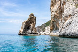 Scenic landscape of Island of Corfu, Greece, western shoreline with cliffs and caves at beach and water line of turquoise or deep blue water with breath taking limestone formations
