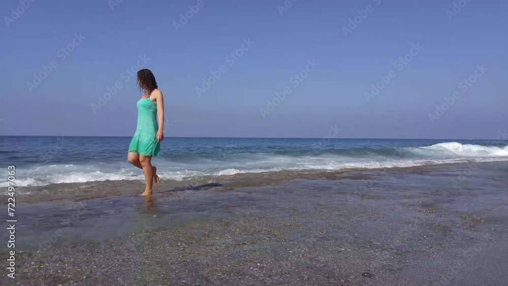Smiling woman splash water on seaside in waves at sunny day Smiling woman splash water on seaside in waves at sunny day
