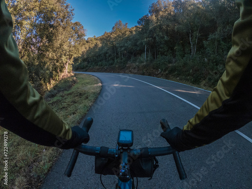 Obraz na plátně Cyclist point of view driving on a lonely road on a blue road bicycle on a beaut