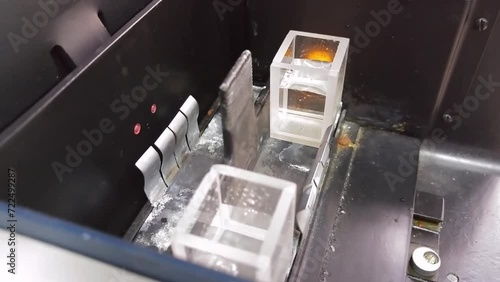 Pipette drop liquid in glass box near lamp in photoelectric colorimeter photo