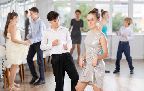 Boy and girl dance energetic twist dance in studio