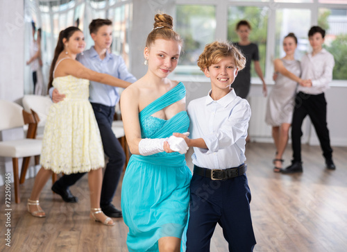 Fototapeta Boy and girl dance couples ballroom dance waltz in studio