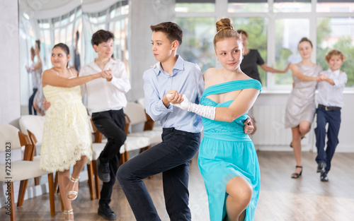 Boy and girl dance energetic twist dance in studio