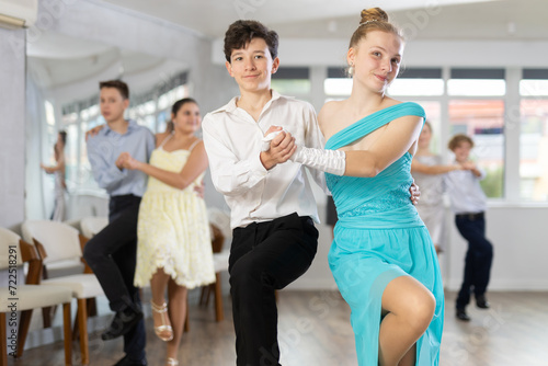 Boy and girl dance energetic twist dance in studio