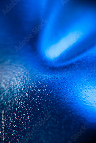 Close-Up View of Blue Light Refraction on a Textured Surface