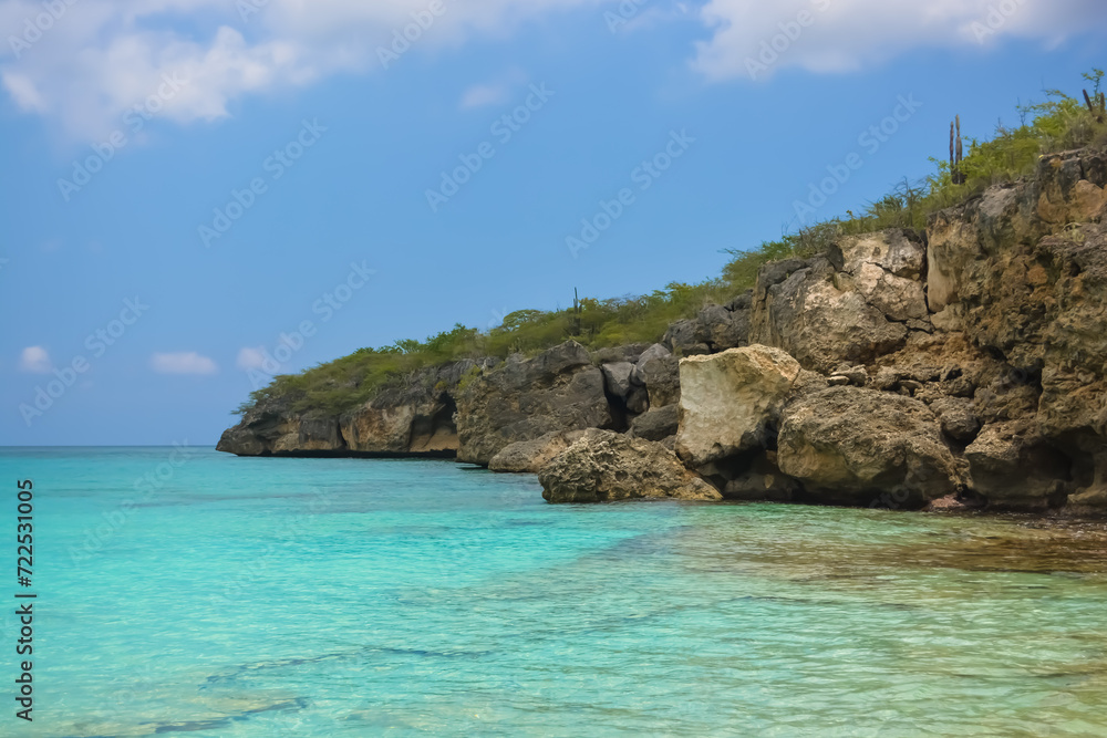 Little Knip beach - paradise white sand beach with blue sky and clear azure water in Curacao, Netherlands Antilles, a Caribbean tropical Island.