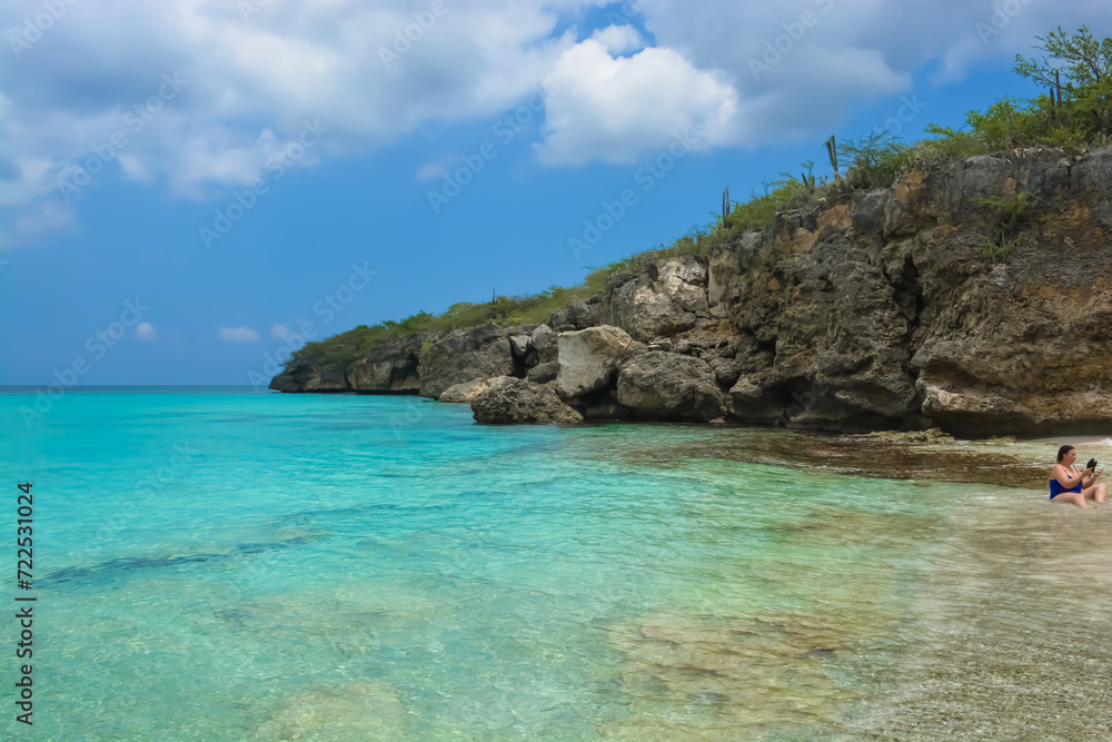 Little Knip beach - paradise white sand beach with blue sky and clear azure water in Curacao, Netherlands Antilles, a Caribbean tropical Island.