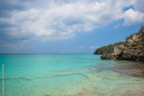 Little Knip beach - paradise white sand beach with blue sky and clear azure water in Curacao, Netherlands Antilles, a Caribbean tropical Island. © Lara Red