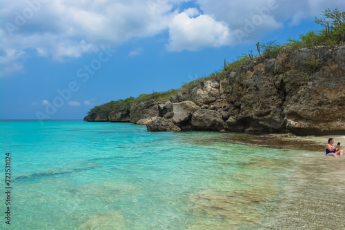 Little Knip beach - paradise white sand beach with blue sky and clear azure water in Curacao, Netherlands Antilles, a Caribbean tropical Island. © Lara Red