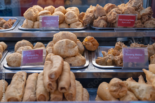 Various gorengan (a popular Indonesian fried food snack) on a display.  photo