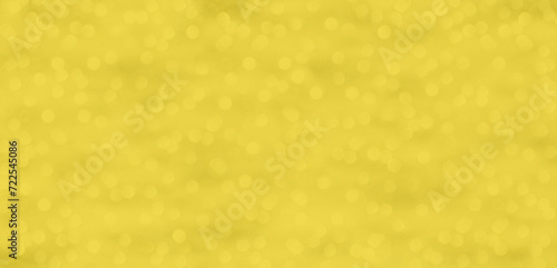 Ein glitzernder gelb goldener Hintergrund mit Lichtpunkten photo