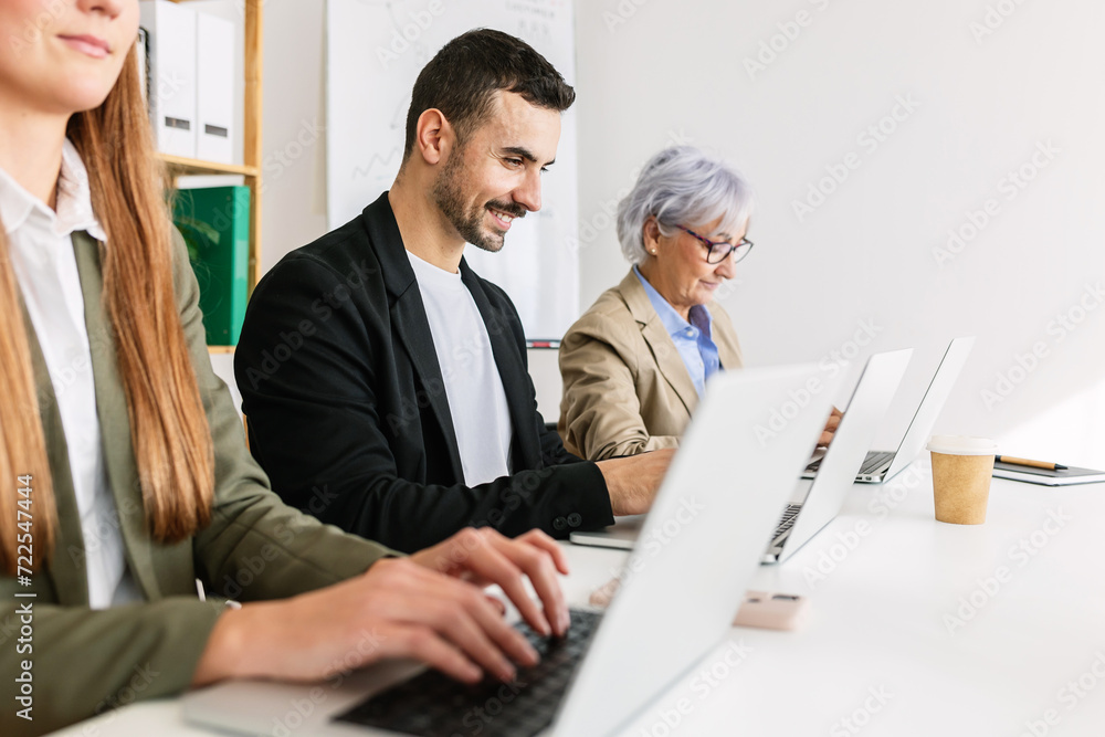 Three diverse hispanic business people working on laptop at bright office. Teamwork and businesspeople concept. Three diverse hispanic business people working on laptop at bright office. Teamwork and businesspeople concept.