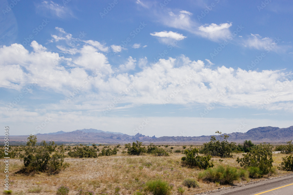 Beautiful blue sky with fluffy clouds over a desert with mountains in Arizona, USA. Panorama with high hills. Landscape on a sunny day Beautiful blue sky with fluffy clouds over a desert with mountains in Arizona, USA. Panorama with high hills. Landscape on a sunny day