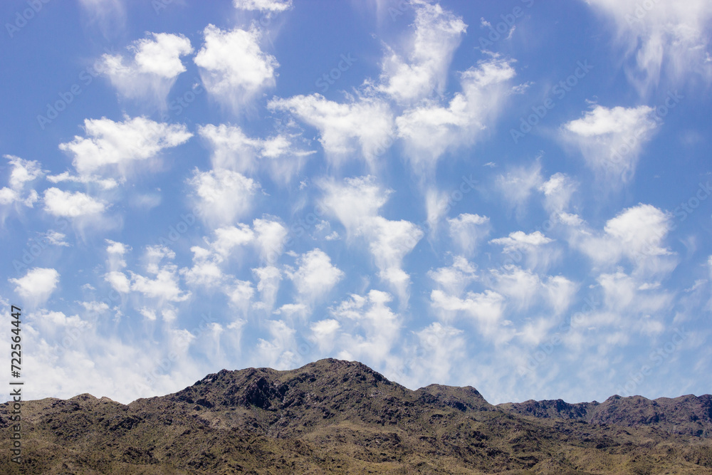 Beautiful blue sky with fluffy clouds over a desert with mountains in Arizona, USA. Panorama with high hills. Landscape on a sunny day Beautiful blue sky with fluffy clouds over a desert with mountains in Arizona, USA. Panorama with high hills. Landscape on a sunny day