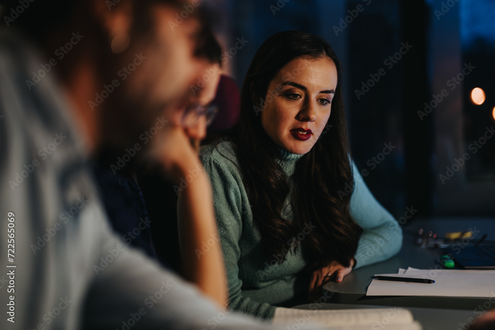 Focused multigenerational coworkers in a collaborative business meeting, illustrating teamwork and strategy in a corporate environment at dusk. Focused multigenerational coworkers in a collaborative business meeting, illustrating teamwork and strategy in a corporate environment at dusk.
