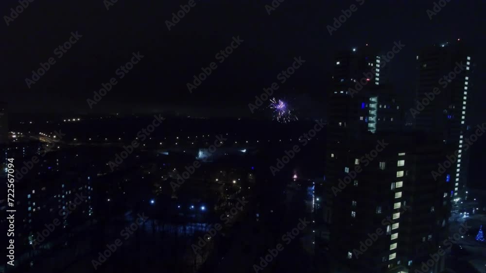 Fireworks explode among houses at rainy night. Aerial view Fireworks explode among houses at rainy night. Aerial view