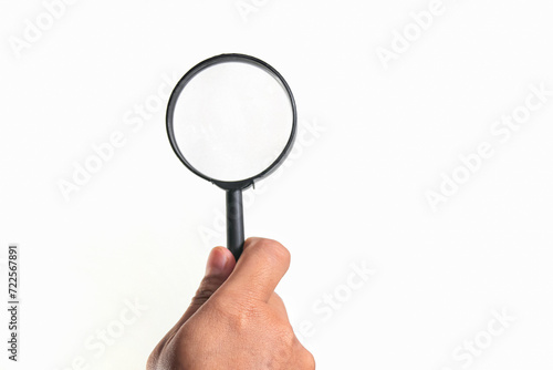 hand holding magnifying glass isolated on white