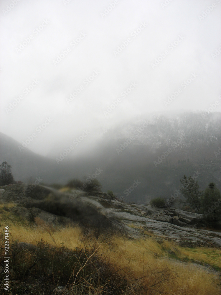 Beautiful foggy landscape photograph.	American national park. Hetch Hetchy valley. Yosemite National Park. 