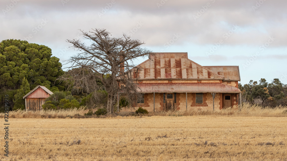 Abandoned old brick farmhouse with a red rusty roof and shed - Yorke Peninsula, South Australia Abandoned old brick farmhouse with a red rusty roof and shed - Yorke Peninsula, South Australia