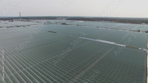 Large area of glassroof gardens greenhouses at winter day. Aerial view photo