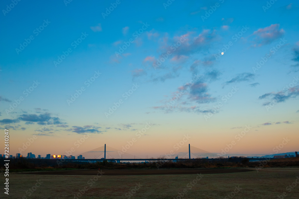 夕暮れ時の都市スカイラインと橋の風景