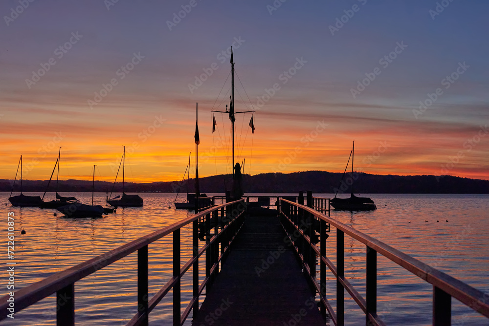Fototapeta premium Bodensee Lake Sunset Panorama. Evening Sunlight Over Tranquil Waters. Sunset Vista at Lake Bodensee in Germany.
