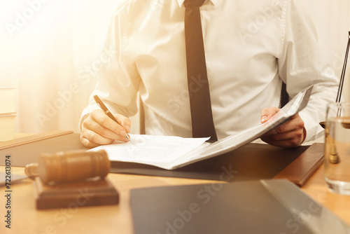 Lawyer working with document at table indoors, closeup